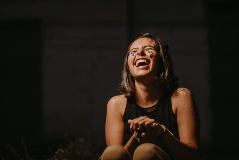 A girl wearing a black top and laughing